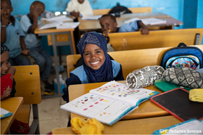 Girl smilles at her desk in classroom in Djibouti